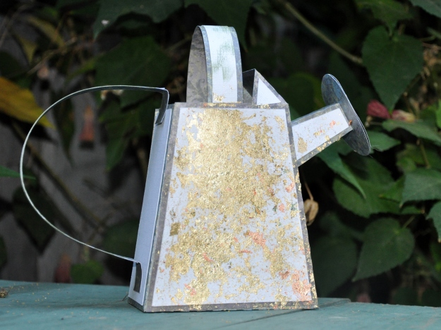 Distressed paper watering can
