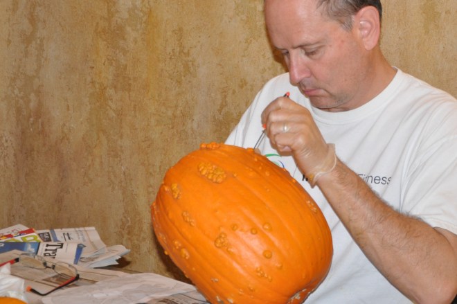 Mike carving pumpkin