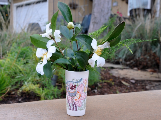 cat vase with camellia and fern
