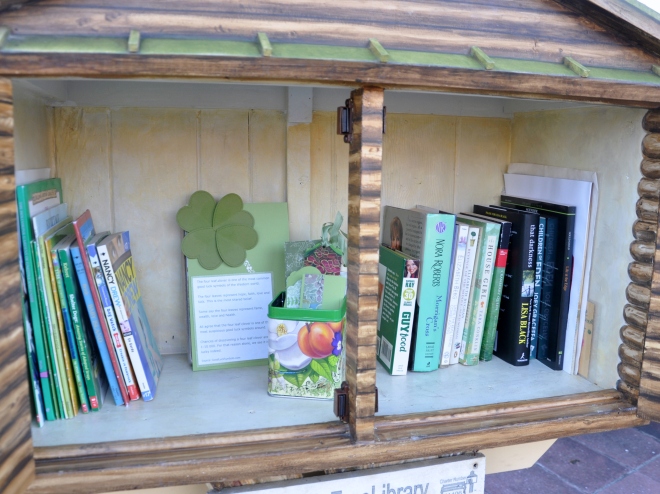 Little Free Library with green books and bookmarks