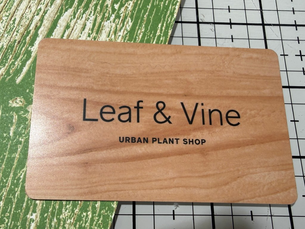 Business card for Leaf & Vine Urban Plant Shop featuring a wooden design.