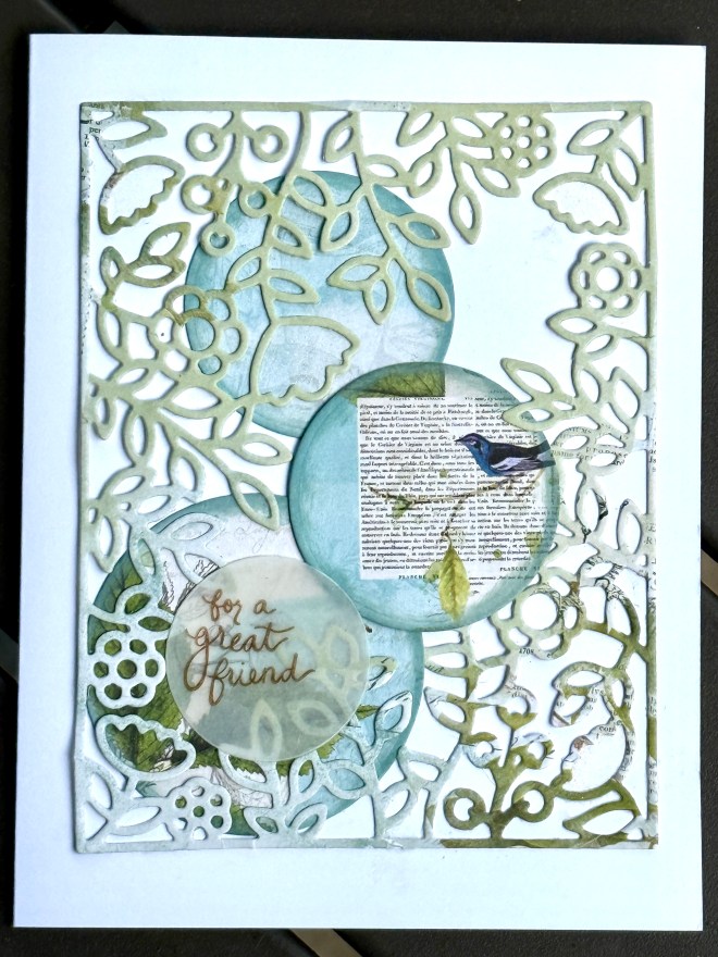 A decorative card featuring intricate die-cut floral and leaf patterns, layered with circles in shades of blue and a translucent overlay with the text 'for a great friend'. A small blue bird is depicted on one of the circles.